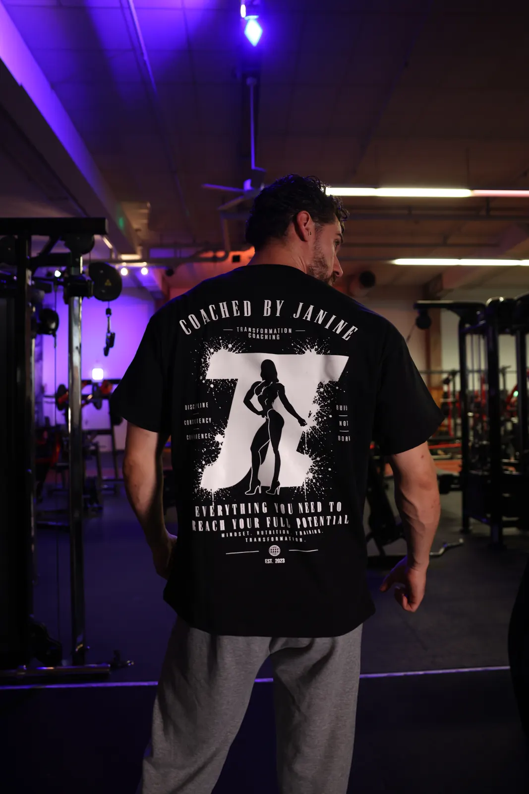 Standard Edition back print with grey sweatpants — the full promise across the back